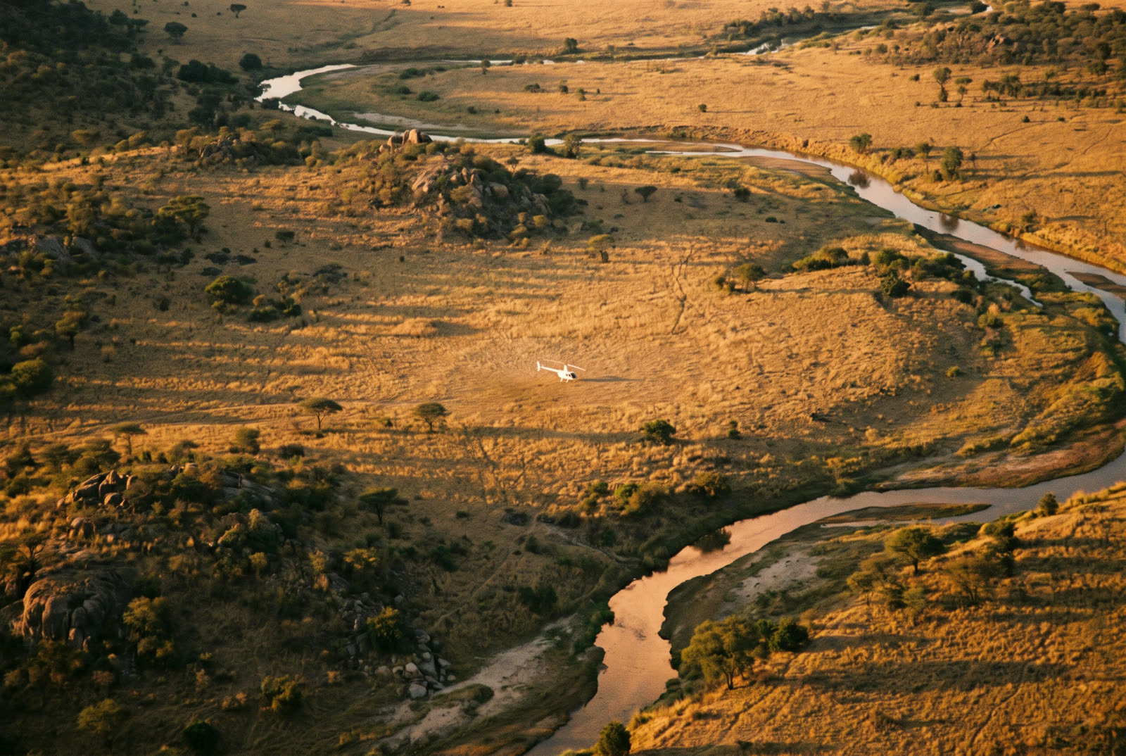 Helicopter on a remote landing site near a lodge